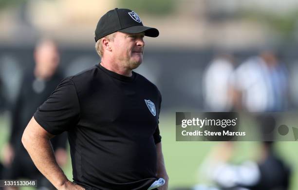 Head coach Jon Gruden of the Las Vegas Raiders watches players warm up during training camp at the Las Vegas Raiders Headquarters/Intermountain...