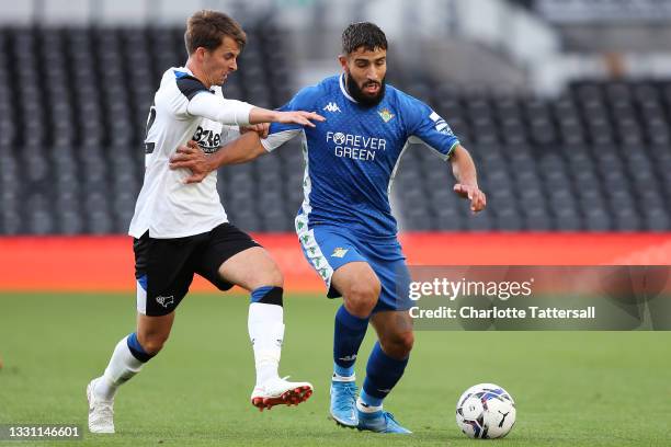 Nabil Fekir of Real Betis is tackled by Tom Carroll of Derby County during the Pre-Season Friendly match between Derby County and Real Betis at Pride...