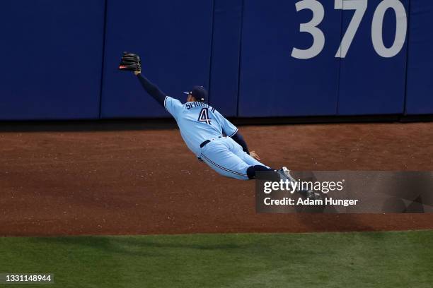 George Springer of the Toronto Blue Jays makes a diving catch on a ball off the bat of Brandon Nimmo of the New York Mets during the third inning at...