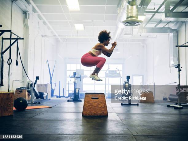 frau in einem cross training gym - frau springt hüpft stock-fotos und bilder