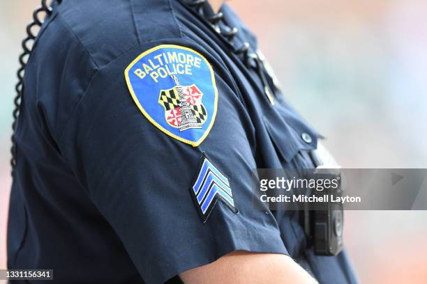 Baltimore city policeman looks on during a baseball game between the Baltimore Orioles and the Washington Nationals at Oriole Park at Camden Yards on...