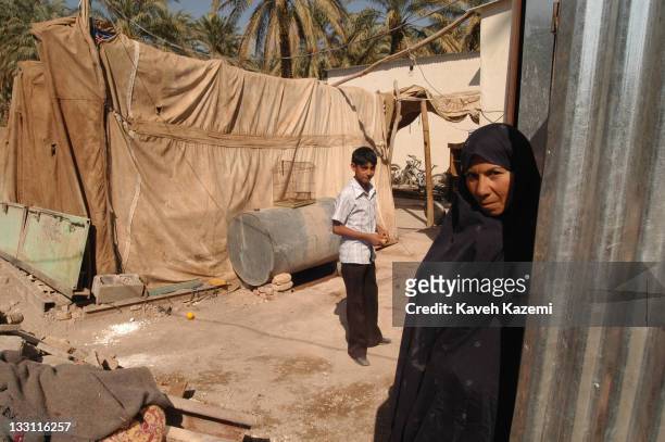 Bam residents camp in tents outside their ruined houses awaiting reconstruction almost a year after a major earthquake struck the city in Bam, Iran,...
