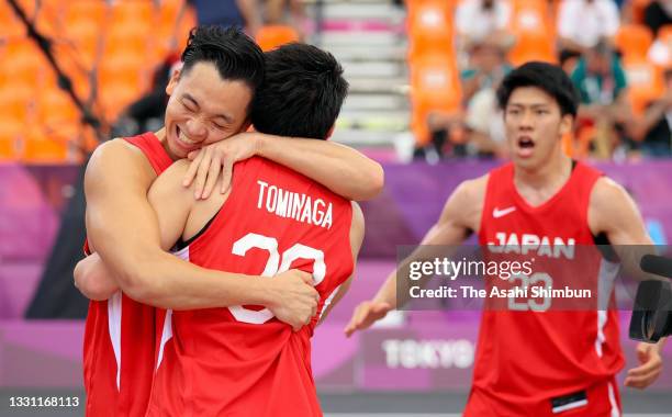 Tomoya Ochiai, Keisei Tominaga and Ryuto Yasuoka of Team Japan celebrate their victory in the Men's 3x3 Pool Round match between China and Japan on...