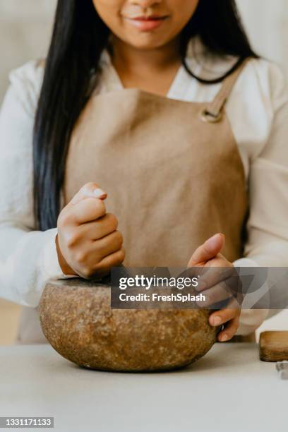 anonymous female chef preparing a tasty meal in the kitchen - mortar and pestle stock pictures, royalty-free photos & images