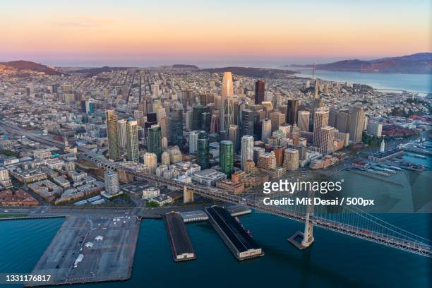 high angle view of city by sea against sky during sunset,san francisco,california,united states,usa - san francisco fotografías e imágenes de stock