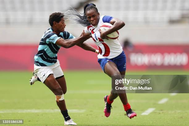 Seraphine Okemba of Team France attempts to evade the tackle of Maria Naimasi Ana of Team Fiji in the Women’s pool B match between Team France and...