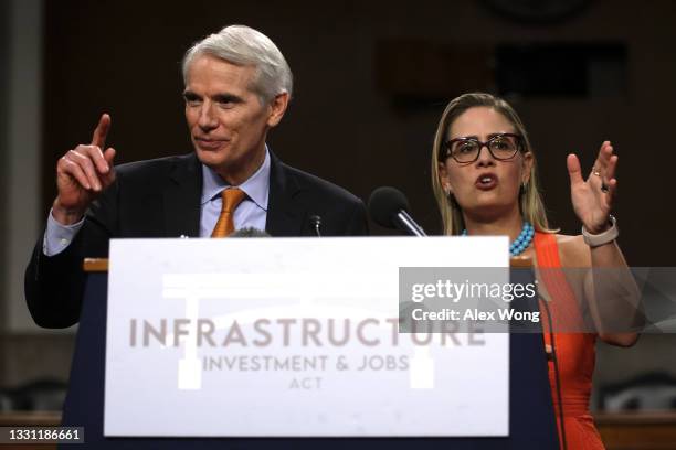 Sen. Rob Portman and Sen. Kyrsten Sinema answer questions from members of the press during a news conference after a procedural vote for the...