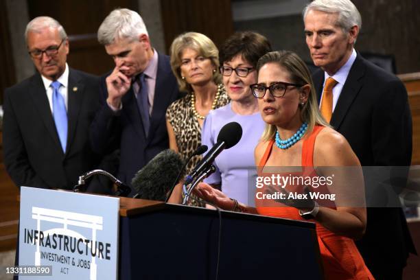 Sen. Kyrsten Sinema speaks as Sen. Kevin Cramer , Sen. Bill Cassidy , Sen. Lisa Murkowski , Sen. Susan Collins and Sen. Rob Portman listen during a...