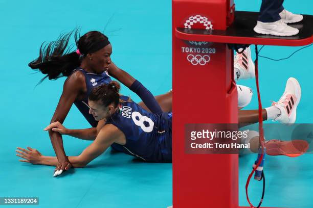 Alessia Orro of Team Italy and Paola Ogechi Egonu collide on the floor against Team Argentina during the Women's Preliminary - Pool B volleyball on...