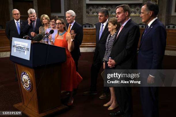 Sen. Kyrsten Sinema speaks as Sen. Kevin Cramer , Sen. Bill Cassidy , Sen. Lisa Murkowski , Sen. Susan Collins , Sen. Rob Portman , Sen. Joe Manchin...