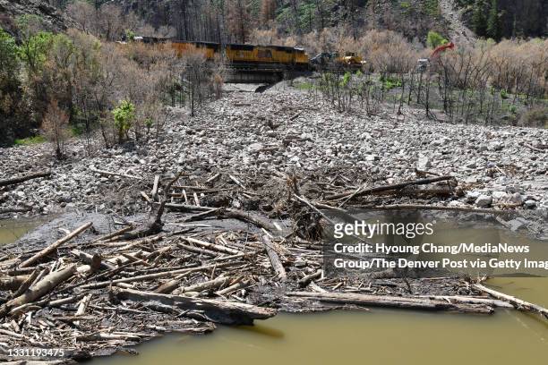 Photo taken Colorado River covered by debris from mudslides near Hanging Lakes Tunnel in Glenwood Springs, Colorado on Wednesday, July 28, 2021.