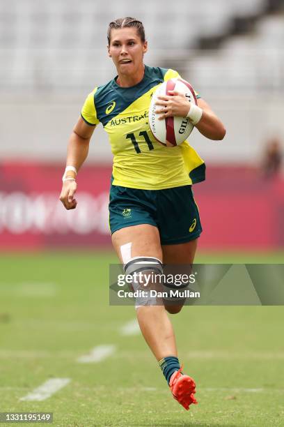 Demi Hayes of Team Australia breaks away to score a try in the Women’s pool C match between Team Australia and Team Japan during the Rugby Sevens on...