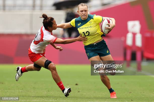 Maddison Levi of Team Australia breaks away from Miyu Shirako of Team Japan to score a try in the Women’s pool C match between Team Australia and...