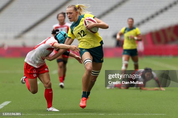 Maddison Levi of Team Australia is tackled on her way to score a try in the Women’s pool C match between Team Australia and Team Japan during the...