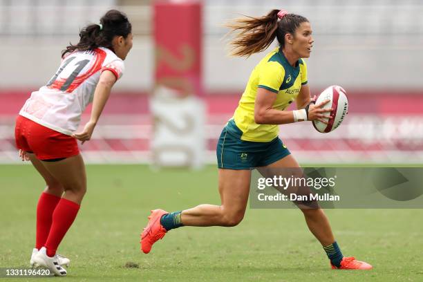 Charlotte Caslick of Team Australia runs the ball in the Women’s pool C match between Team Australia and Team Japan during the Rugby Sevens on day...