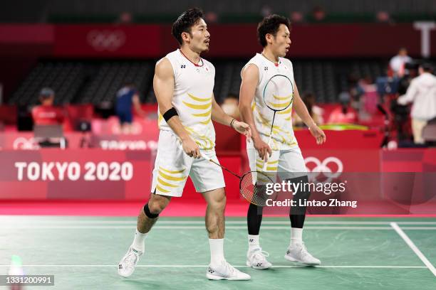 Takeshi Kamura and Keigo Sonoda of Team Japan react as they compete against Mohammad Ahsan and Hendra Setiawan of Team Indonesia during a Men’s...