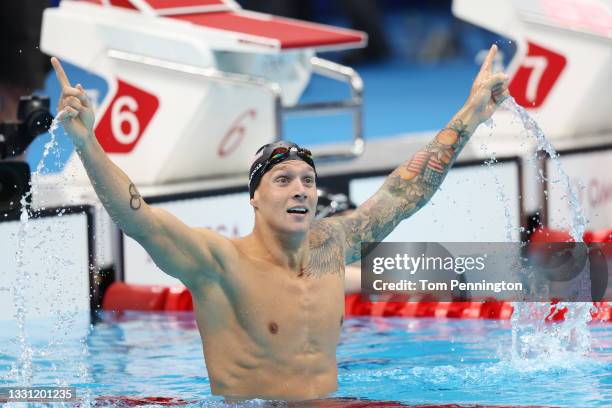 Caeleb Dressel of Team United States celebrates after winning the gold medal and breaking the olympic record in the Men's 100m Freestyle Final on day...