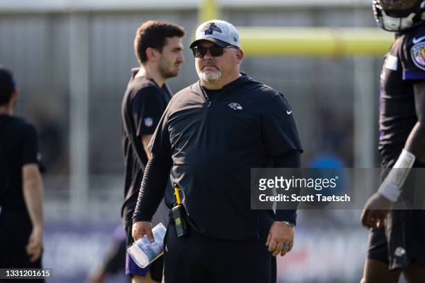 Offensive coordinator Greg Roman of the Baltimore Ravens watches play during training camp at Under Armour Performance Center Baltimore Ravens on...