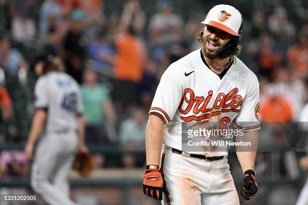 Ryan McKenna of the Baltimore Orioles celebrates after being walked to score the winning run against the Miami Marlins at Oriole Park at Camden Yards...