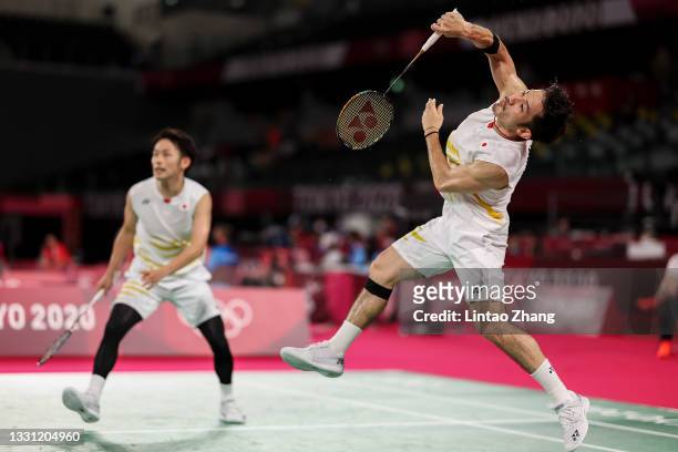 Takeshi Kamura and Keigo Sonoda of Team Japan react as they compete against Mohammad Ahsan and Hendra Setiawan of Team Indonesia during a Men’s...