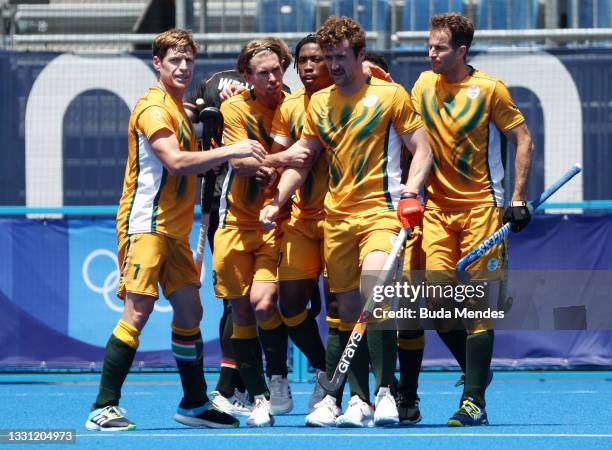 Matthew Guise-Brown of Team South Africa celebrates scoring the first goal with Timothy Drummond and teammates during the Men's Preliminary Pool B...