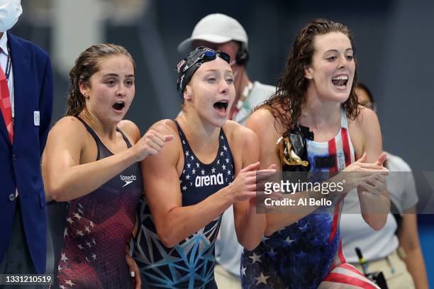 Kathryn McLaughlin, Paige Madden and Allison Schmitt react as Katie Ledecky of Team United States swims the final leg in the Women's 4 x 200m...