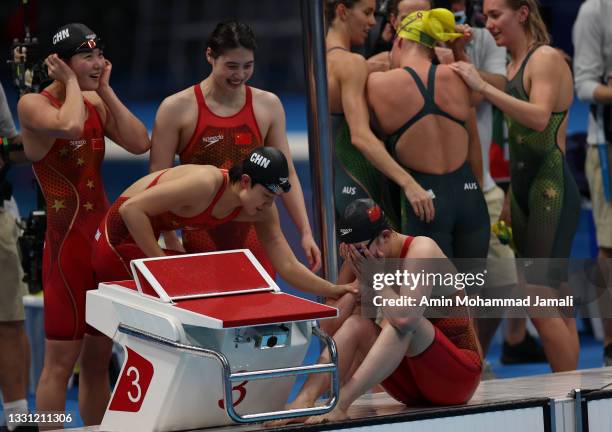 Junxuan Yang, Muhan Tang, Yufei Zhang and Li Bingjie of Team China celebrate after winning gold in the Women's 4X200 meter freestyle relay on on day...