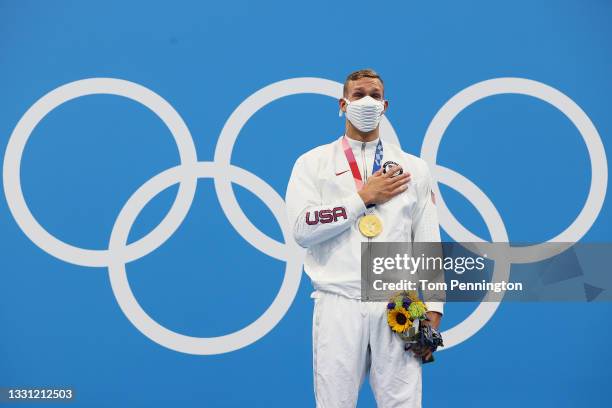 Caeleb Dressel of Team United States poses with the gold medal during the medal ceremony for the Men's 100m Freestyle Final on day six of the Tokyo...