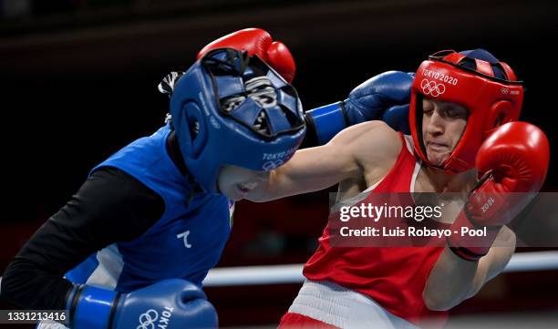 Buse Naz Cakiroglu of Team Turkey exchanges punches with Tursunoy Rakhimova of Team Uzbekistan during the Women's Fly on day six of the Tokyo 2020...