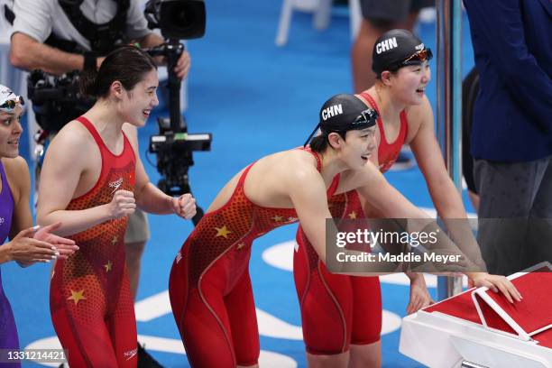 Yang Junxuan, Tang Muhan and Zhang Yufei of Team China celebrates winning gold in the Women's 4 x 200m Freestyle Relay Final on day six of the Tokyo...