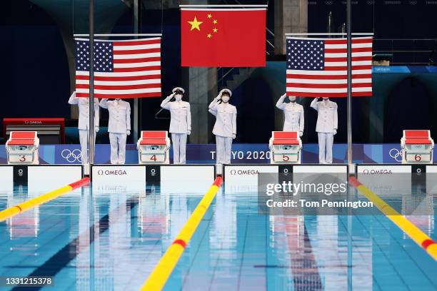 The flags of Team United States and Team China are raised during the medal ceremony for the Women's 200m Butterfly Final on day six of the Tokyo 2020...