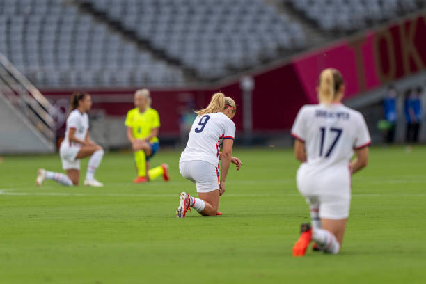 Lindsey Horan of the USWNT kneels during a game between Sweden and USWNT at Tokyo Stadium on July 21, 2021 in Tokyo, Japan.