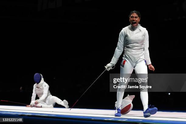Ysaora Thibus of Team France, right, celebrates after defeating Arianna Errigo of Team Italy to advance to the Gold Medal Match in Women's Foil Team...