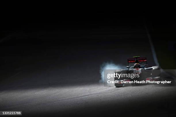 British McLaren Formula One team racing driver Lewis Hamilton driving his MP4-27 racing car towards the La Source hairpin and locking the right front...