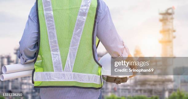 female engineer working in a power plant - petrochemie stock-fotos und bilder