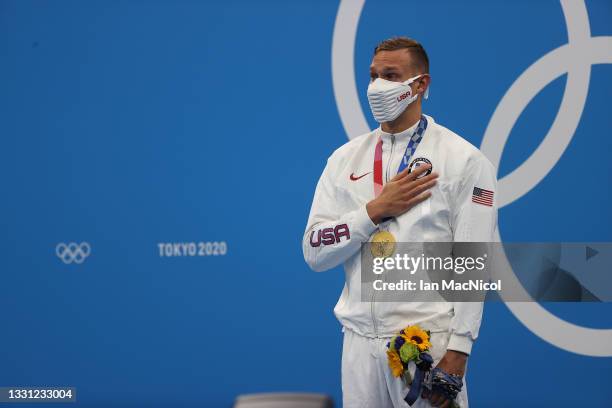 Caeleb Dressel of United States is seen on the podium with his gold medal after winning the Men's 100m Freestyle final on day six of the Tokyo 2020...