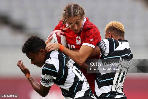 Kaili Lukan of team Canada is tackled by Viniana Riwai and Alowesi Nakoci of Team Fiji in the Women’s pool B match between Team Canada and Team Fiji...