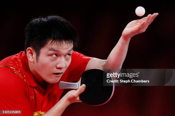 Fan Zhengdong of Team China serves the ball during his Men's Singles Semifinals match on day six of the Tokyo 2020 Olympic Games at Tokyo...