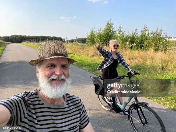 grandpa on bicycle with granddaughter - cycling netherlands stock pictures, royalty-free photos & images