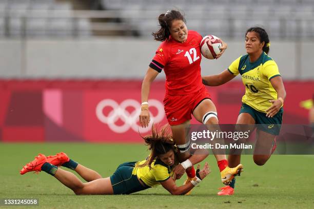 Hongting Ruan of Team China is tackled by Charlotte Caslick and Sariah Paki of Team Australia in the Women’s pool C match between Team Australia and...