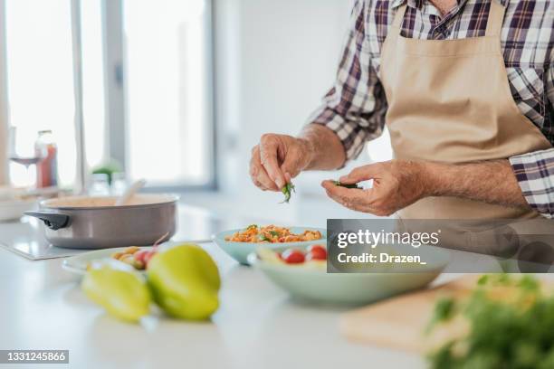 nutritionist cooking at home and preparing salad - mediterranean food stock pictures, royalty-free photos & images