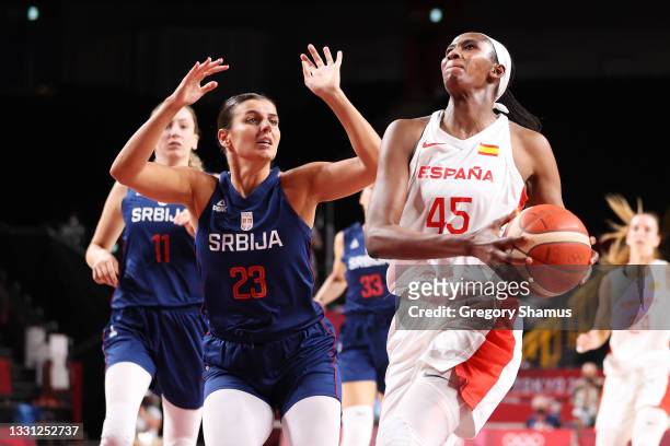 Team Spain centre Astou Ndour drives to the basket against Team Serbia shooting guard Ana Dabovic during the first half of a Women's Preliminary...