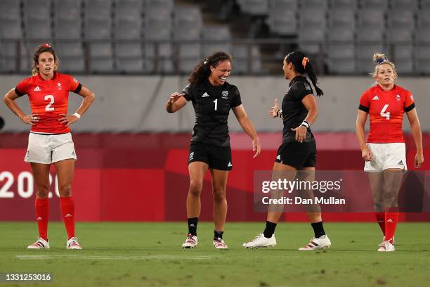 Abbie Brown and Natasha Hunt of Team Great Britain look dejected after defeat as Ruby Tui of Team New Zealand and Stacey Fluhler of Team New Zealand...