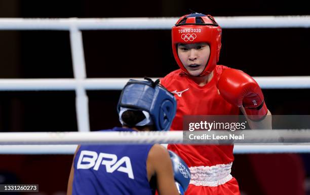 Tsukimi Namiki Team of Japan exchanges punches with Graziele Sousa of Team Brazil during the Women's Fly on day six of the Tokyo 2020 Olympic Games...