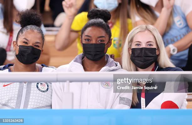Jordan Chiles, Simone Biles, and Mykayla Skinner of Team United States, look on during the Women's All-Around Final on day six of the Tokyo 2020...