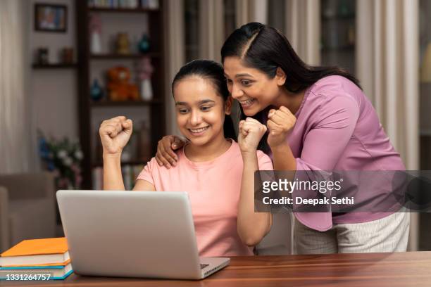 shot of a very happy mother and daughter using laptop for examining test result - test results stock pictures, royalty-free photos & images