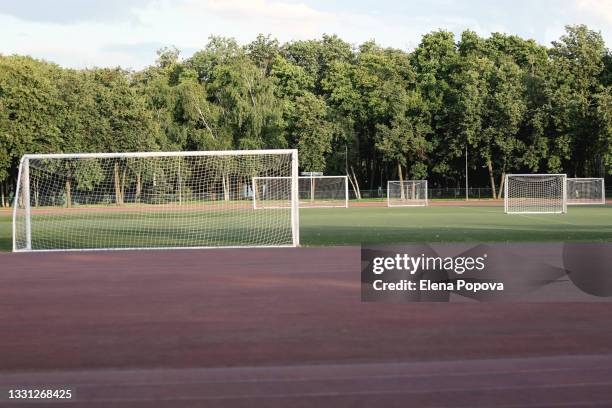 empty multi-goal soccer field for school training - trainingsgelände stock-fotos und bilder