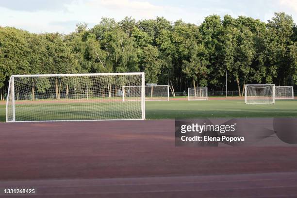 empty multi-goal soccer field for school training - campo di allenamento foto e immagini stock