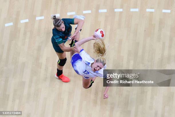 Vladlena Bobrovnikova of Team ROC shoots at goal whilst being challenged by Noemi Hafra of Team Hungary during the Women's Preliminary Round Group B...