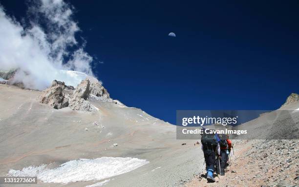 guided mountaineering team making a carry up to high camp on aconcagua, andes mountains, argentina - mount aconcagua stock pictures, royalty-free photos & images